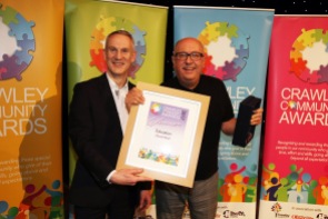 DM17311565a.jpg. Crawley Community Awards, 2017. David Reid receives the Education award from Mark Haynes. Photo by Derek Martin